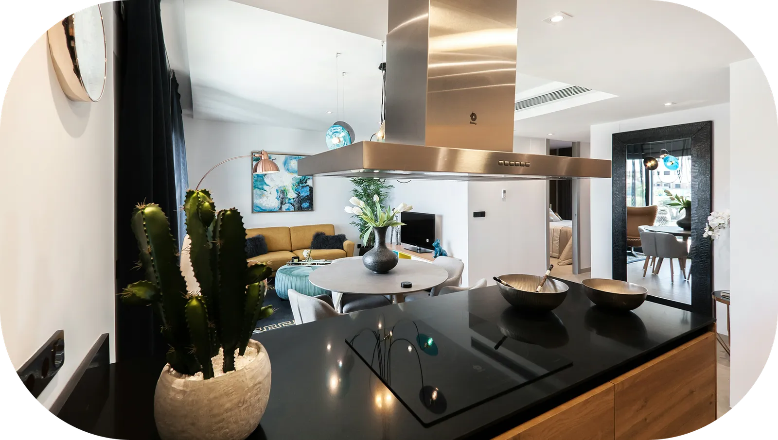 Modern open-plan kitchen and living room with a black granite worktop